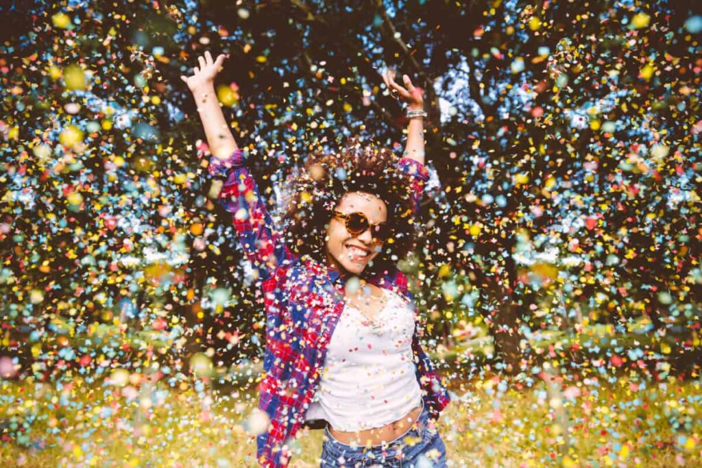 person enjoys shower of confetti outside
